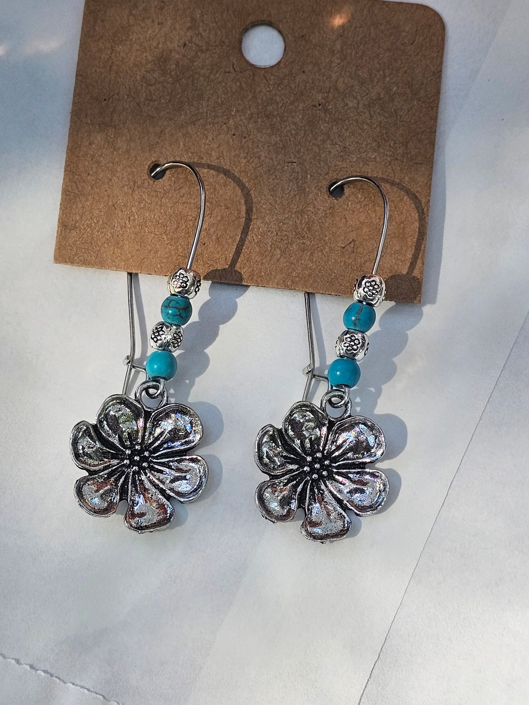 Metal flower with seed beads on kidney wire