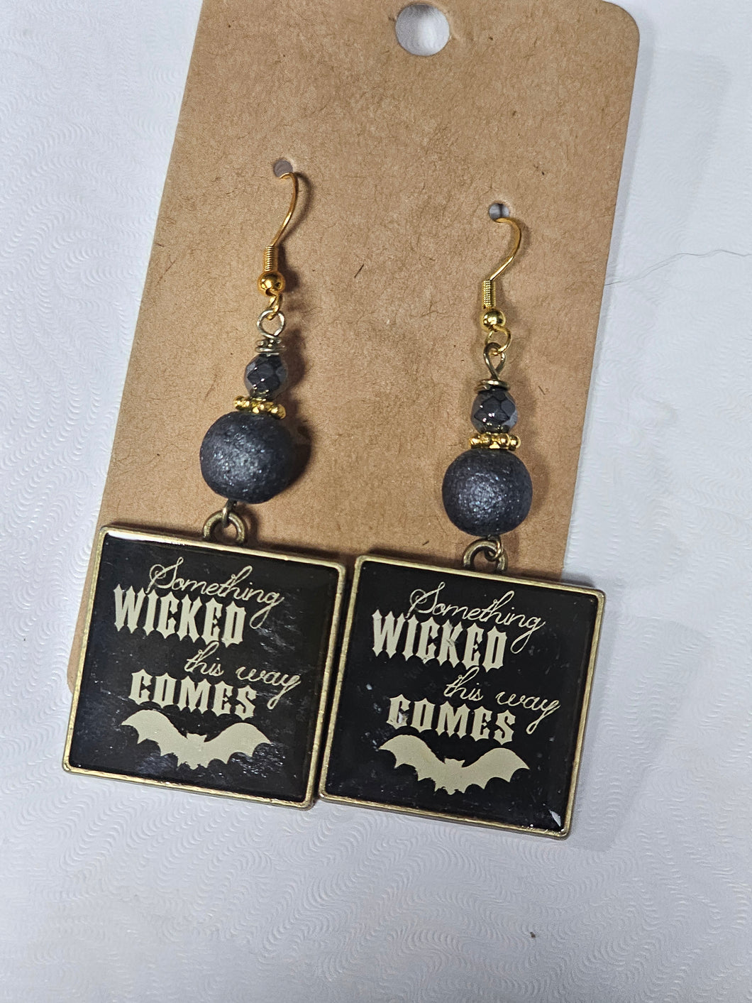 Metal charm with beads, something wicked